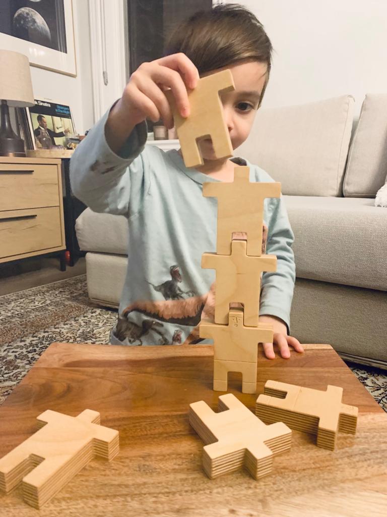 A  boy playing with The Stacking Peeps